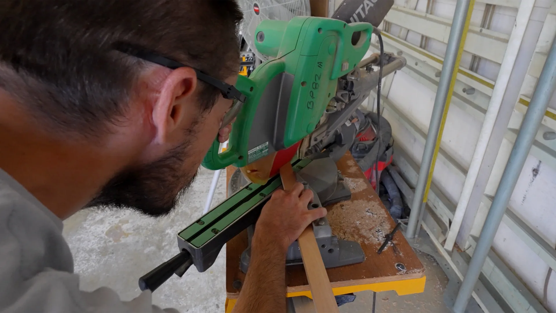 Technician drilling hardware on a boat during yacht service in Oxford